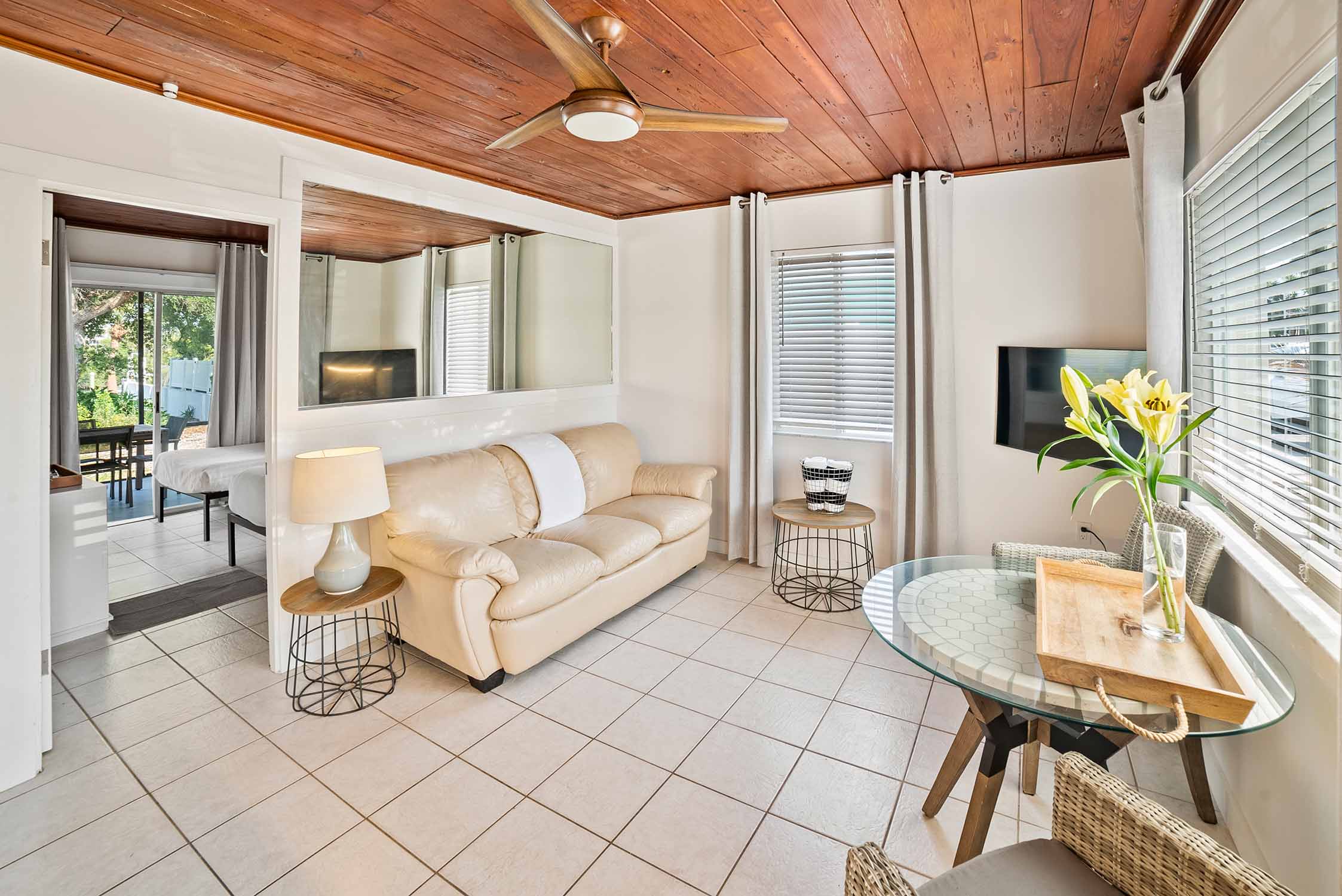 One Bedroom Bayfront - Living Area, Bedroom and View Out Back Patio